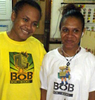 2 members of PNG Box of Books Project, wearing BOB t-shirts