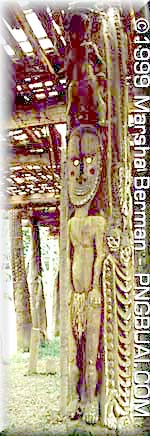 carved post and structure in Papua New Guinea